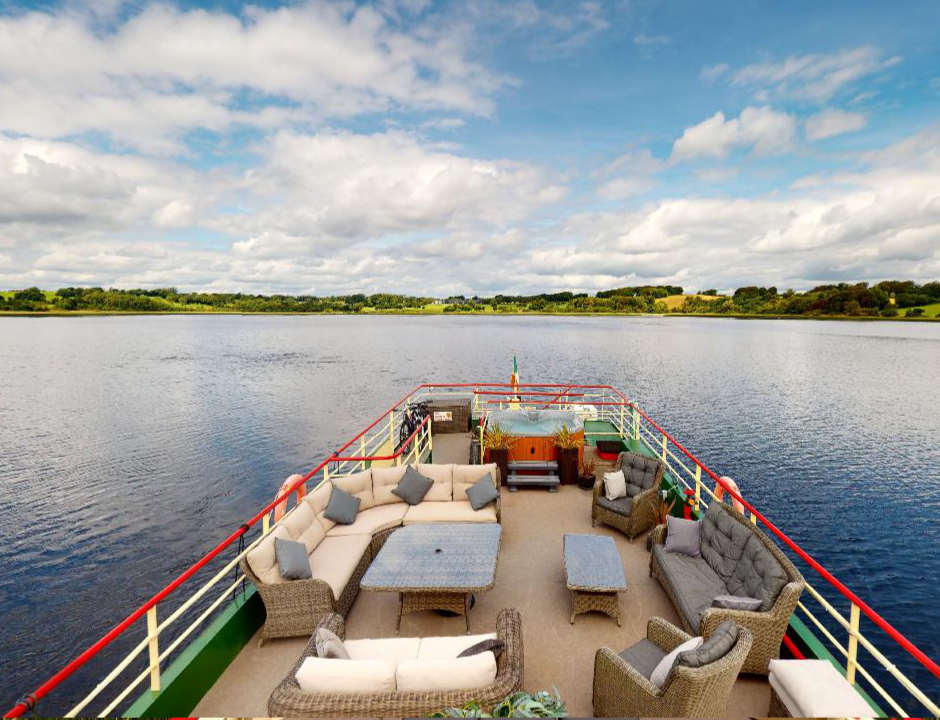 Sun deck on the Shannon Princess Shannon Princess deck with facilities for passengers and the river landscape in the background
